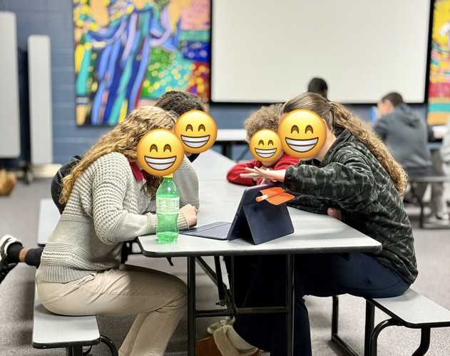 Kids working together on an iPad