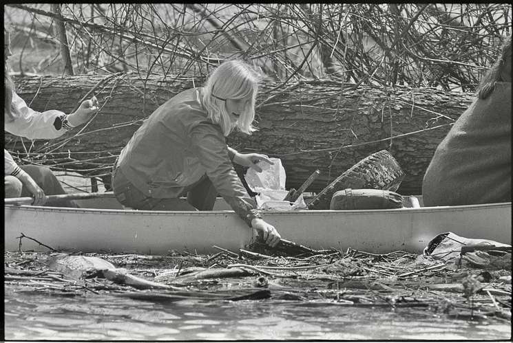 [Girl Scout in canoe, picking trash out of the Potomac River during Earth Week] April 22, 1970 - Library of Congress.