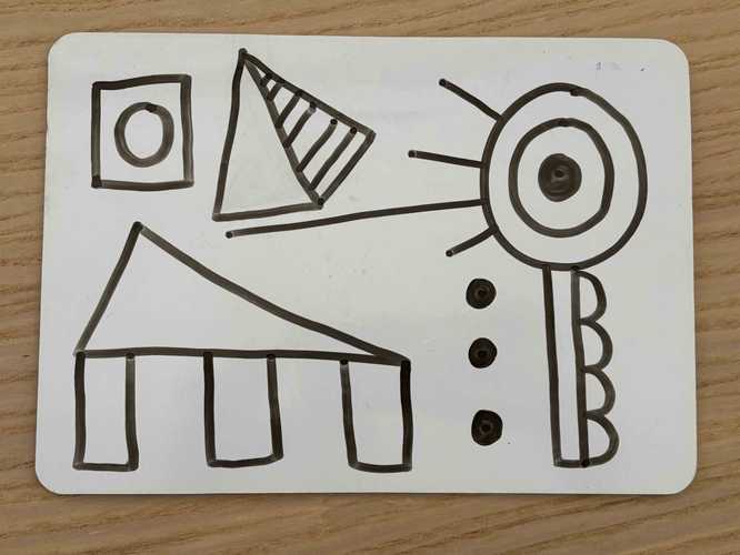 A mini-whiteboard showing geometric shapes combined to make patterns.