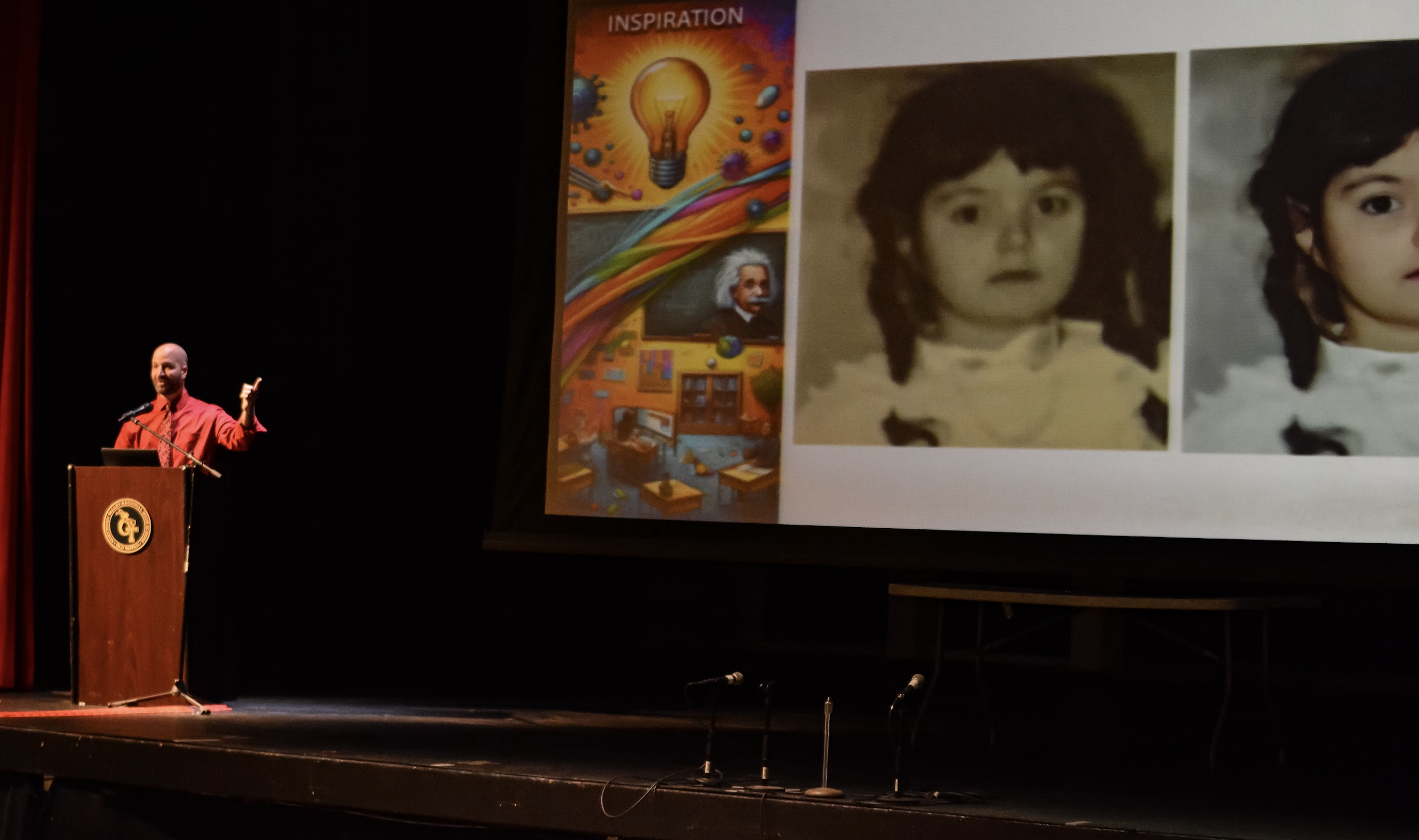 Marc on stage, pointing to the projector screen showing an old photograph, presenting at the New Jersey AI Literacy Summit.