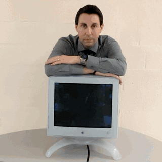 Gif of a man leaning on an iMac G3 with arms crossed. The image slowly transitions to Pop Art style with vibrant colors