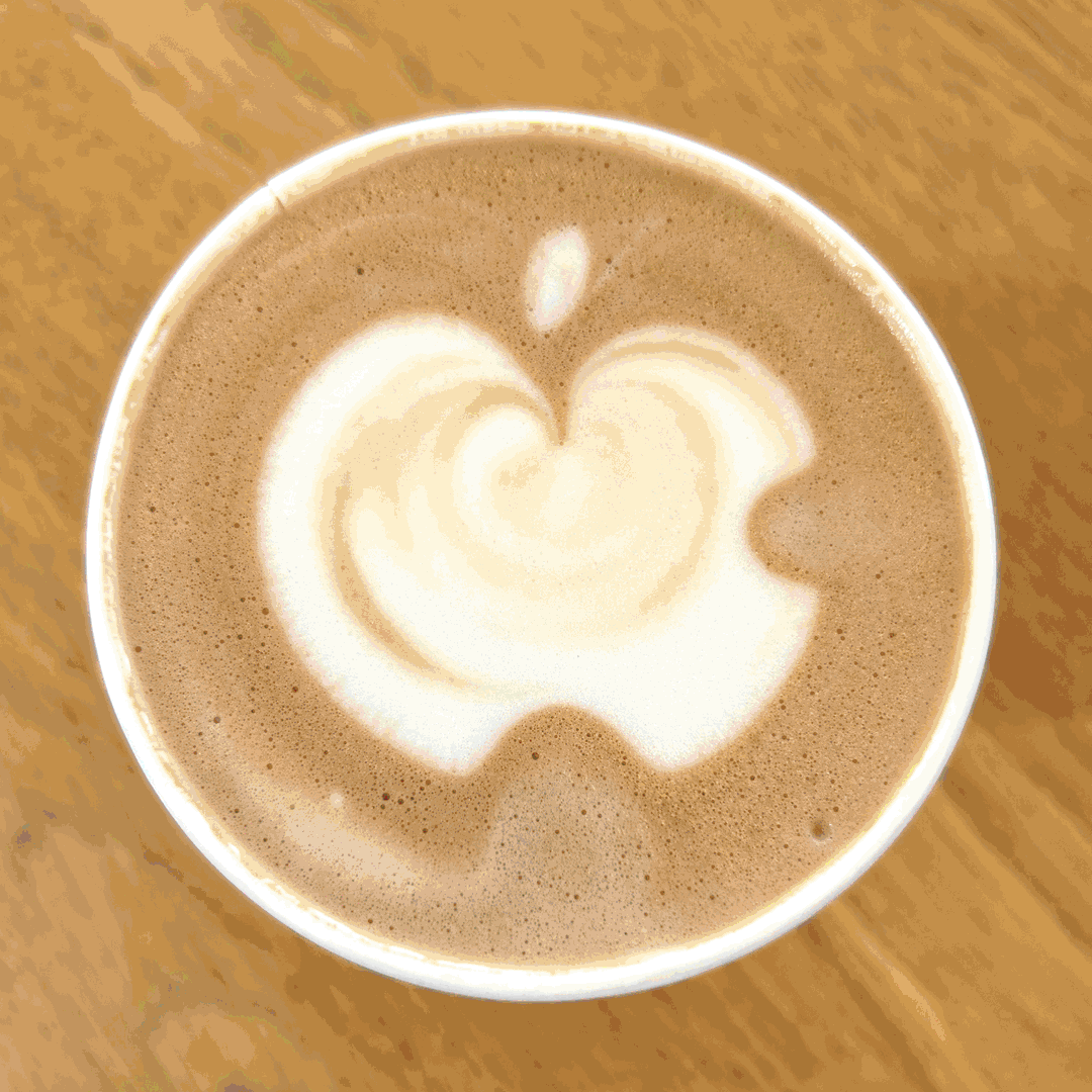 A GIF of images of an overhead view of a latte with the Apple logo created with foam art, each image enhanced with color.