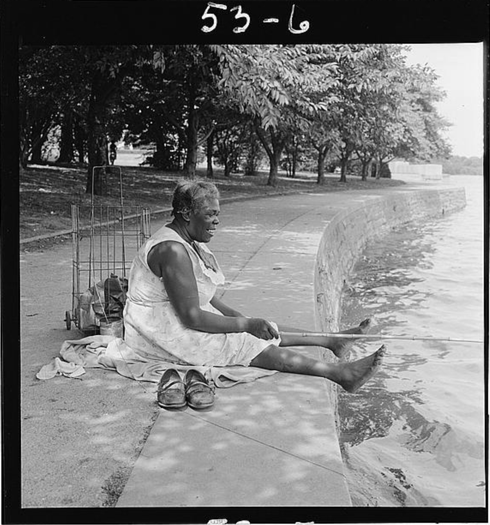 [African American woman, seated on ground, fishing, at the Tidal Basin, Washington, D.C.]  - Library of Congress  (1957)
